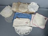 a lot of doily and handkerchiefs sitting on a couch