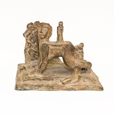 statue of a dog with a man and a woman sitting on it