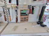 a picture of a workbench with tools hanging on it