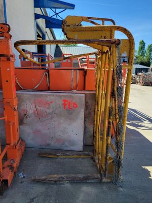 a forklift that is sitting in front of a building