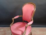an image of a pink chair sitting on top of a carpeted floor