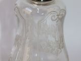a clear glass bottle with a gold top