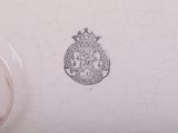 a close up of a white vase with a crown on it
