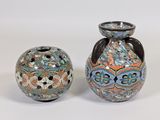 two vases sitting next to each other on a white surface