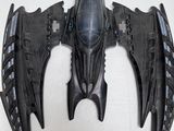 a black batmobile that is sitting on a white surface