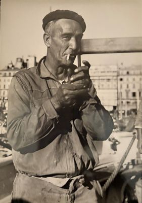 a black and white photo of a man smoking a cigarette