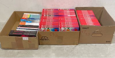 several boxes of books are stacked on top of each other