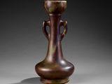 a brown vase that is sitting on a table