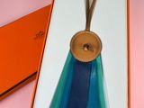 a box with a blue ribbon and a brown tag in it