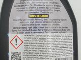 a close up of a bottle of cleaner on a white surface