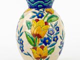 a blue vase with yellow and blue flowers on it
