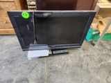 a television sitting on top of a table in a room