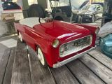 a red toy car that is sitting on a wooden table
