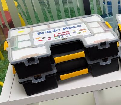 many boxes of legos sitting on a shelf in a room