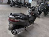 many motorcycles parked in a garage with a number plate on the back of the bike