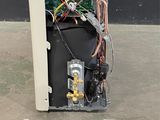 a computer that is sitting on the ground next to a remote control