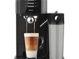 a black coffee machine with a cup of coffee in front of it