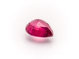 a close up of a pink diamond on a white surface