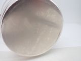 a silver object that is sitting on a white surface