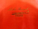 a close up of a red shirt with gold writing on it