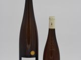 two bottles of wine sitting next to each other on a table
