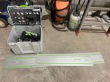 a tool box with tools on the floor next to a ladder