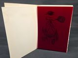 an open book with a drawing of a flower on it
