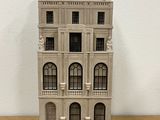 a small model of a building on a wooden table