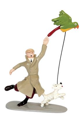 figurine of a man flying a kite with a dog on a leash