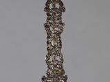 an antique silver spoon with an ornate design on it