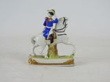 a figurine of a man riding on a horse