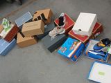a pile of shoes and boxes on the ground