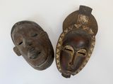 pair of african masks on white background