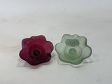 two pieces of glass sitting on a white surface