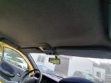 dashboard view of a car with the sun shining through the windshield