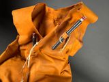 a brown bag with a pen and a pencil inside of it