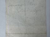 an old piece of paper with writing on it sitting on top of a table