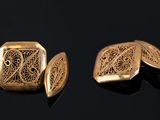 two pieces of gold colored metal with intricate designs on them
