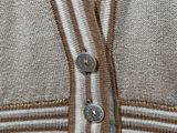 close up of a person ' s sweater with buttons on the front