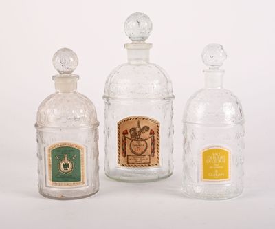 three glass bottles that are sitting next to each other