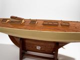 a wooden model of a boat on display on a table