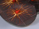 two round trays that have red and yellow designs on them