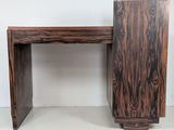 two pieces of wood sit on top of each other in front of a white wall