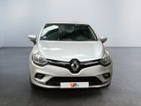 the front view of a white car parked in a room
