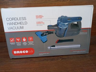 the box of the cordless handheld vacuum is open on the table