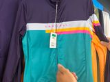 a woman that is looking at some clothes on a rack