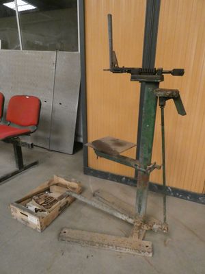two red chairs in a room with a machine on the floor
