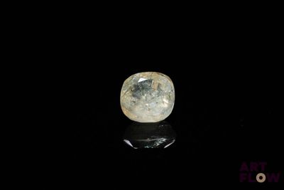 a close up of a white diamond on a black surface