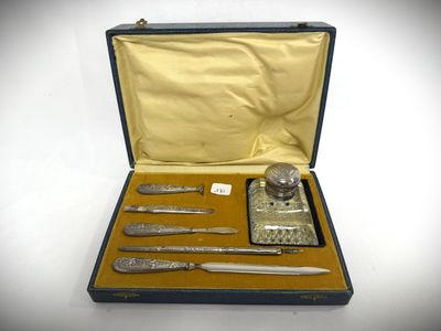 a case that has a set of knives and a bottle in it