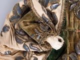 an image of a woman ' s dress with a gold and green design